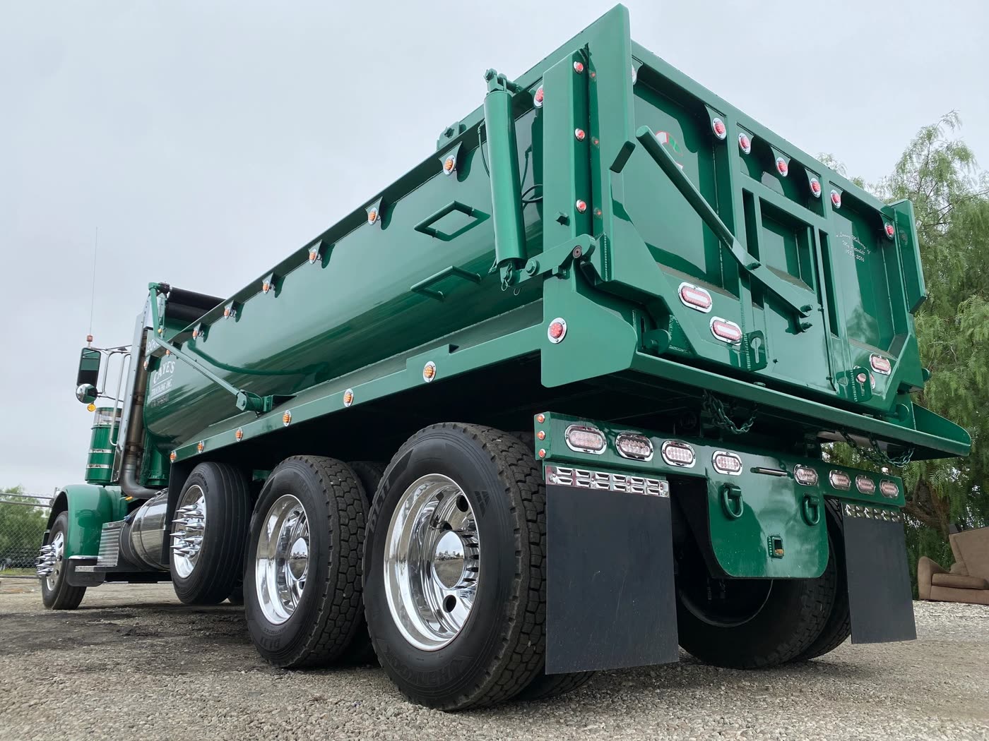 Custom dump body finished in green, built by DM Welding