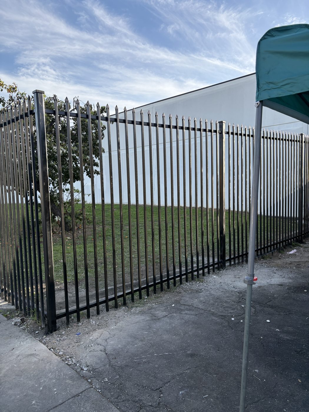 Ornamental iron picket fence with spear tops and square posts, built by DM Welding