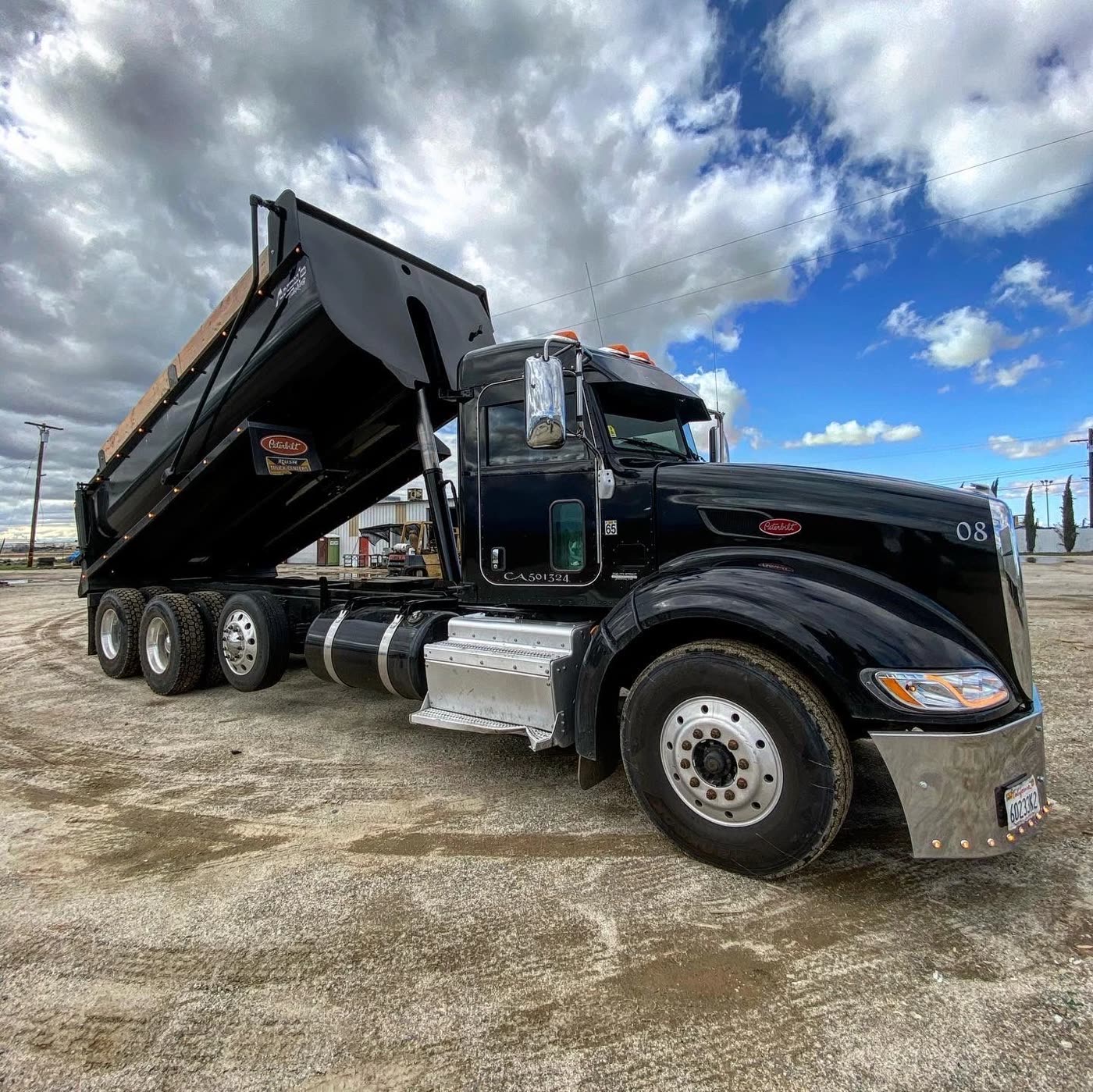 Truck chassis and raised dump body at the DM Welding shop