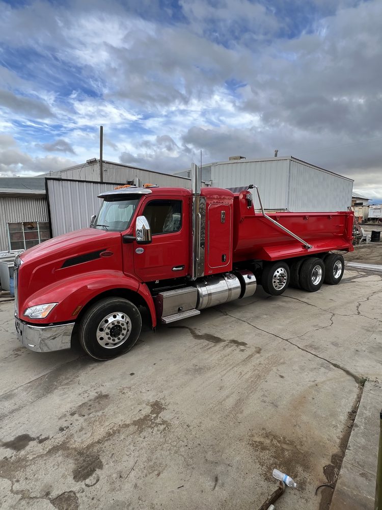 Red Peterbilt day cab with a matching red dump body