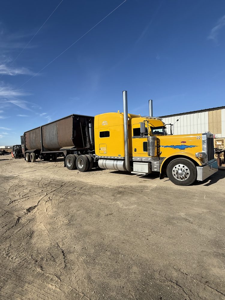Yellow tractor coupled to a transfer trailer