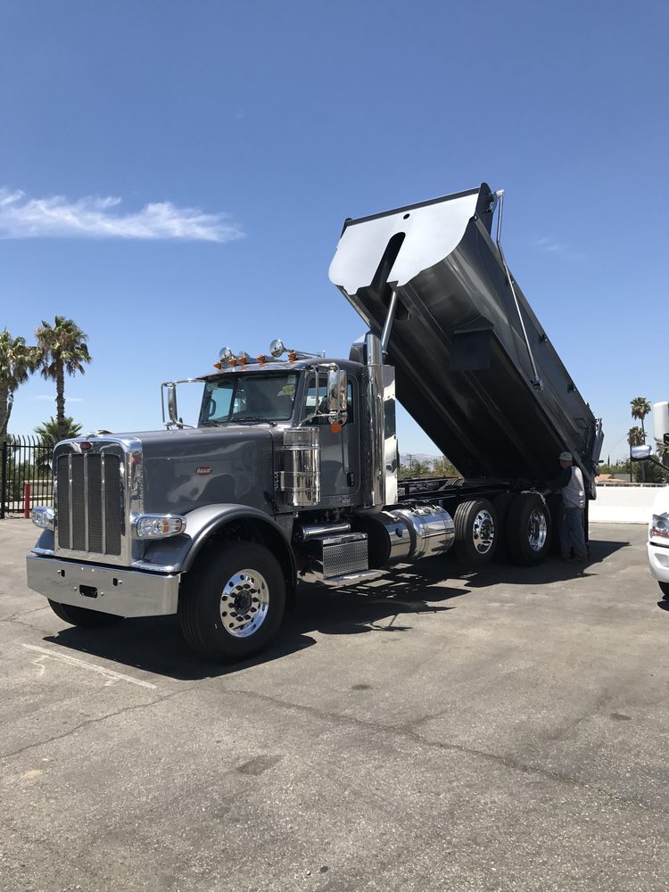 Black dump body raised on a chrome trimmed truck