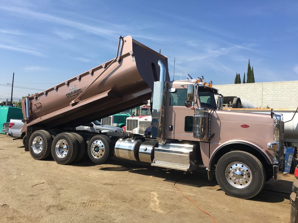 Tan dump body raised on its chassis