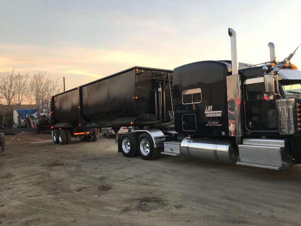 End dump trailer and tractor at dusk