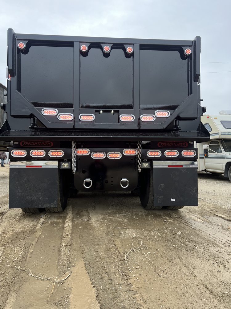 Black dump body square from the rear, tailgate closed